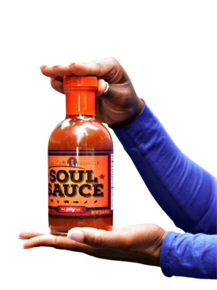 Bottle of Mr. Levi's Soul Sauce held in a woman's hands